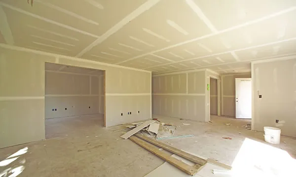 Room with new drywall hung, taped and finished, ready for primer
